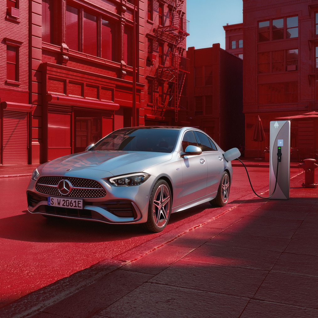 Dynamický pohľad na sedan Mercedes-Benz Triedy C (jazdná situácia) alebo počas státia na nabíjacej stanici.