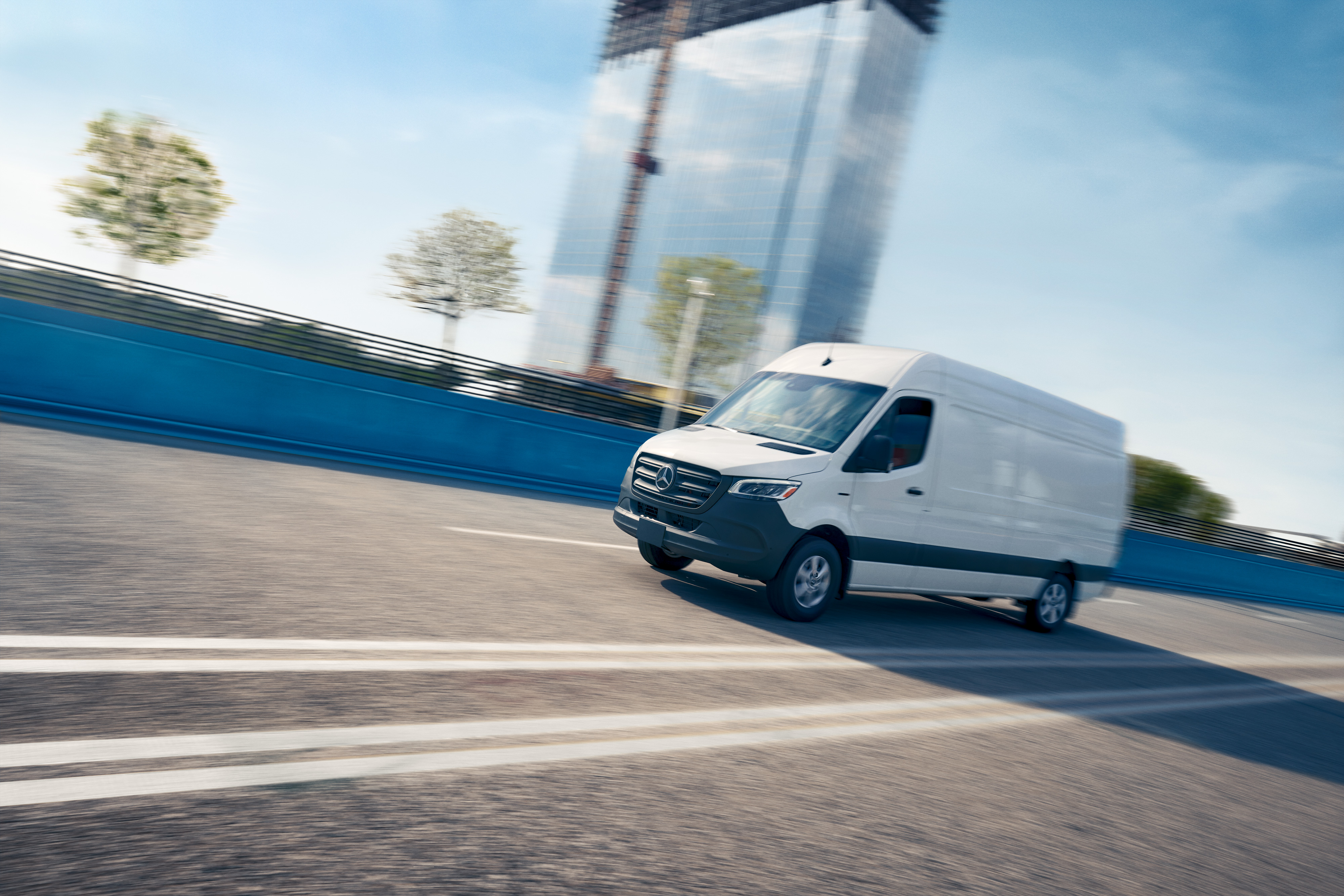 Mercedes-Benz | Technológia úžitkových vozidiel | OSA Biele úžitkové vozidlo jazdí po ceste, reklama na servisnú aplikáciu Mercedes-Benz s online rezerváciou termínu.